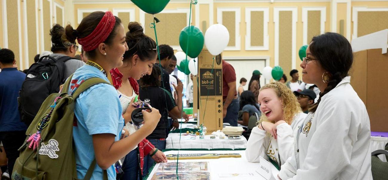 Students browse tables at the Majors Fair.